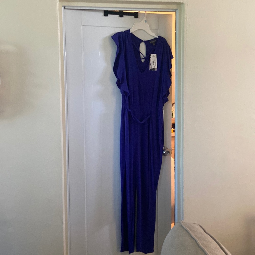 Selling a dark blue jumpsuit with tags size large.